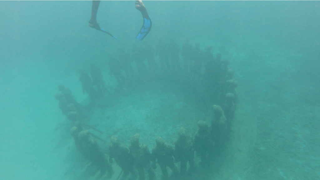 Standing ring of people in Grenada underwater sculpture park