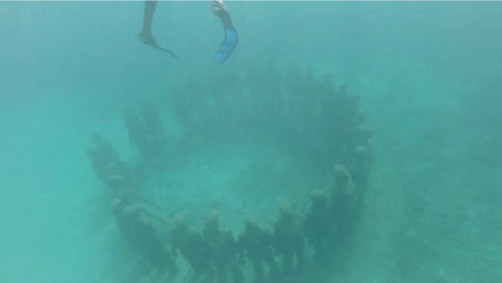 Standing ring of people in Grenada underwater sculpture park