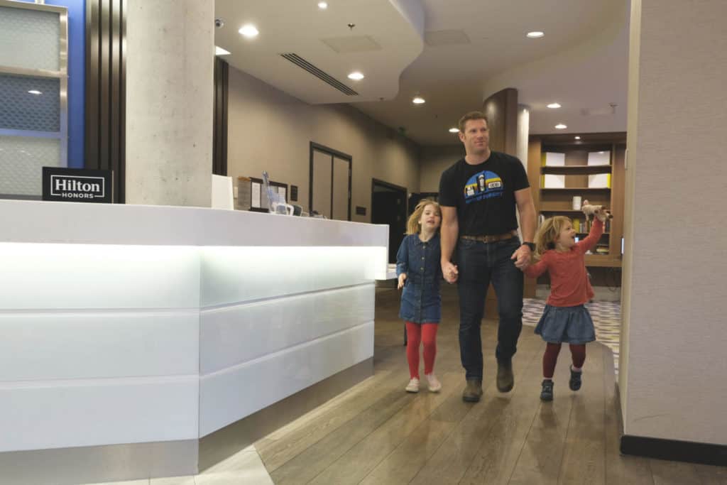 Family walking through reception at Hampton by Hilton Waterloo in London
