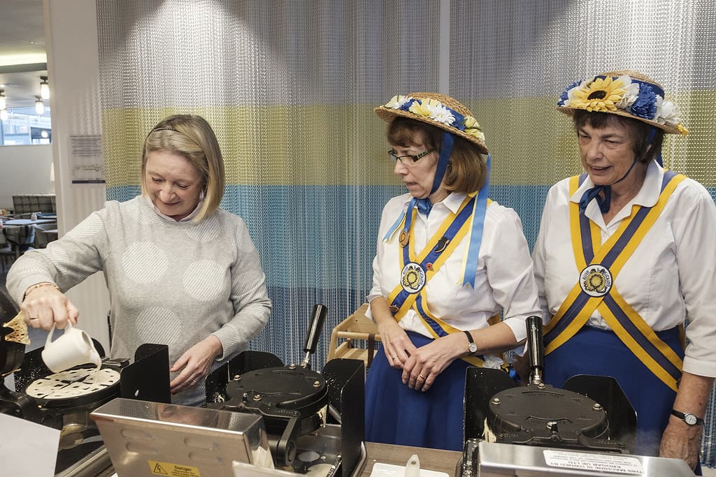 Sally from Linlithgow, gets to grips with the wonder of a waffle
much to the bafflement of Morris dancers, Gillian and Ruth. The photo series, entitled This Is Real Travel, was captured by one of the UKs leading documentary photographers - Ian Weldon. Appointed by hotel brand, Hampton by Hilton, as their Realist in Residence, Weldon captured images during a weekend at one of their UK hotels, to celebrate the real side of British travel