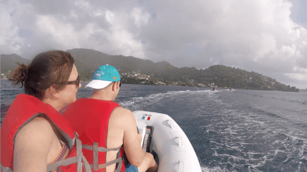 Claire and Mr Tin Box on two-person powerboat, powering along the coast of Grenada