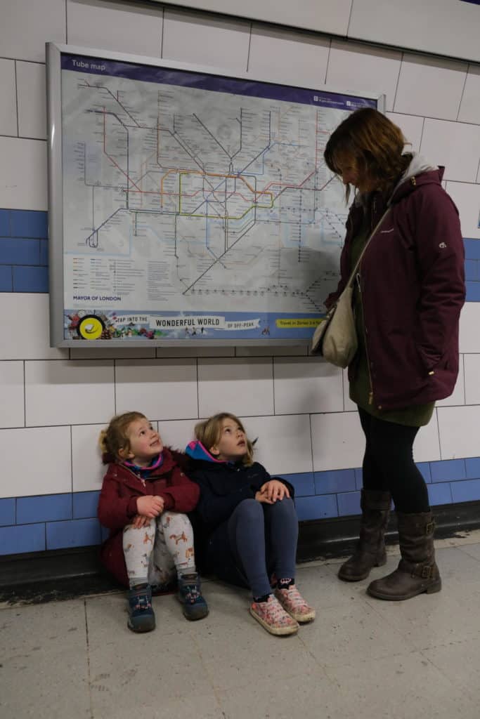 Kids sat on floor in Green Park tube station