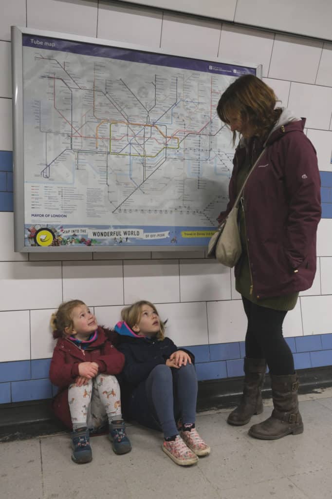 Kids sat on floor in Green Park tube station