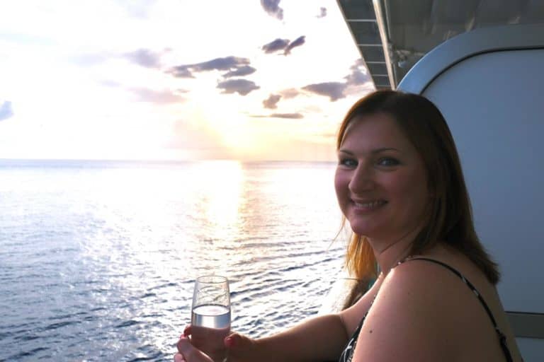 Claire having a glass on wine on cruise ship balcony at sunset - are is the P&O drinks package worth it?