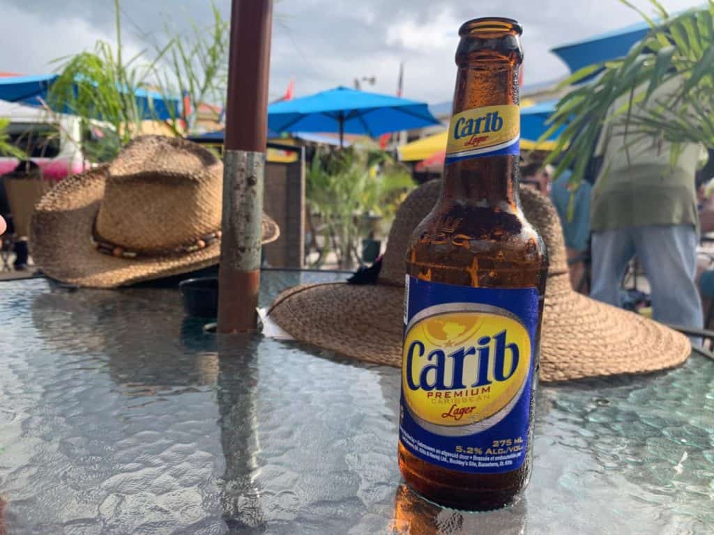 Bottle of Carib lager on bar table in Caribbean