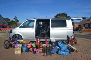 VW T5 with camping kit beside it