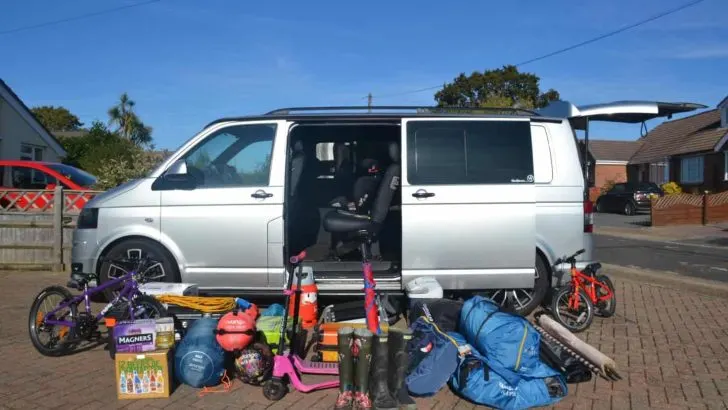 VW T5 with camping kit beside it