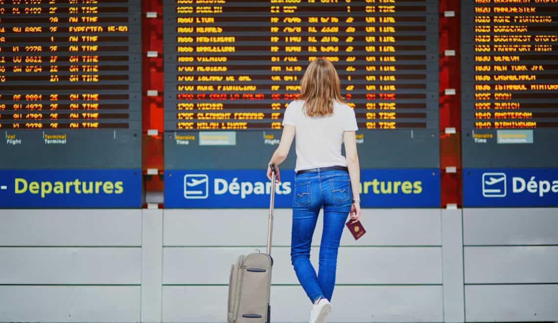 Young woman in international airport - cancelled holidays