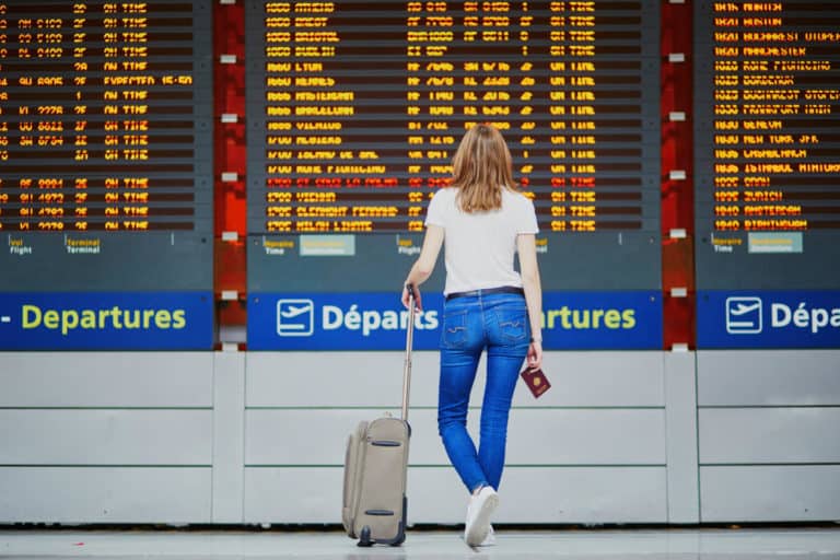 Young woman in international airport - cancelled holidays