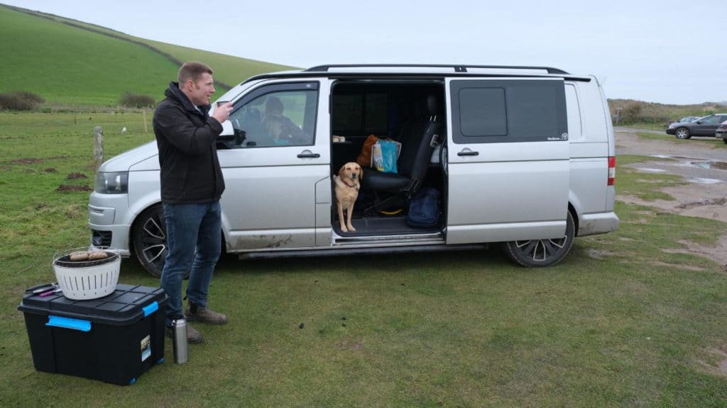 Barbecuing beside silver VW T5 van with side door open