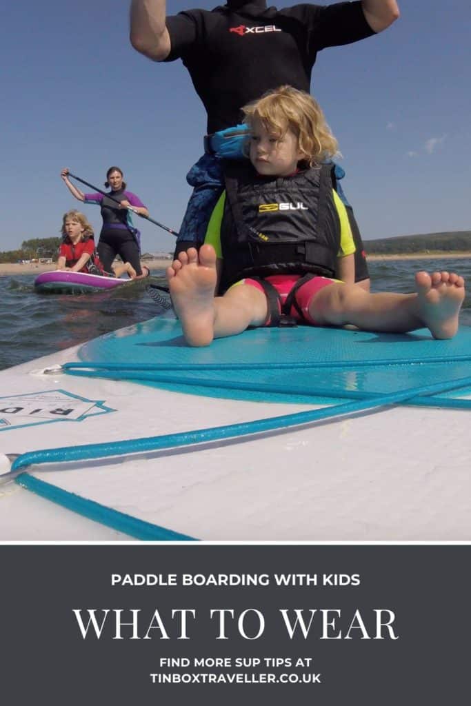 You need more than something to ride to try out stand up paddle boarding or SUP with your family. Here’s what we recommend you wear paddle boarding with kids for comfort, safety and practicality #SUP #paddleboard #watersport #beach #outdoors #fun #family #kids #TinBoxTraveller #wear #clothes #equipment