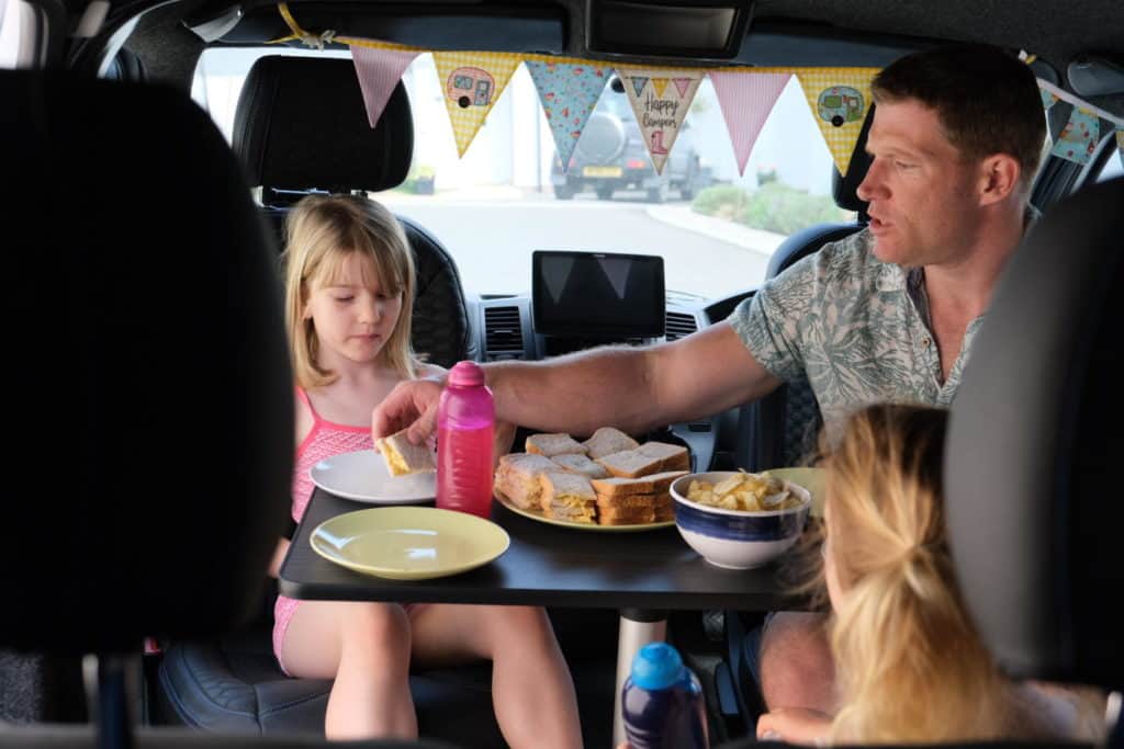 Family eating in van for Big Little TeaTime Festival