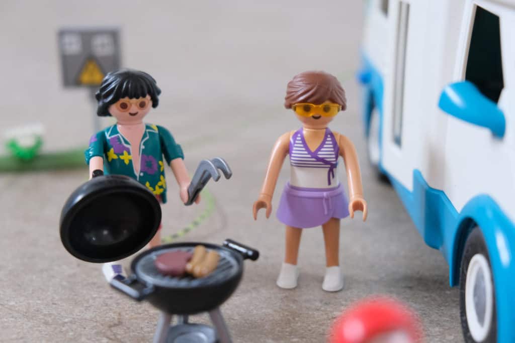 PLAYMOBIL figures standing with barbecue