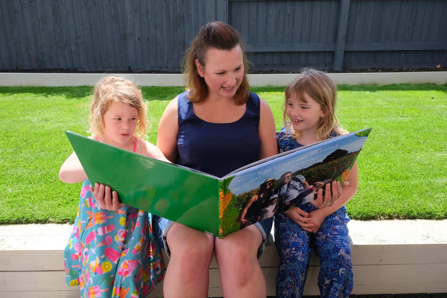 Family looking at photo book my My Picture