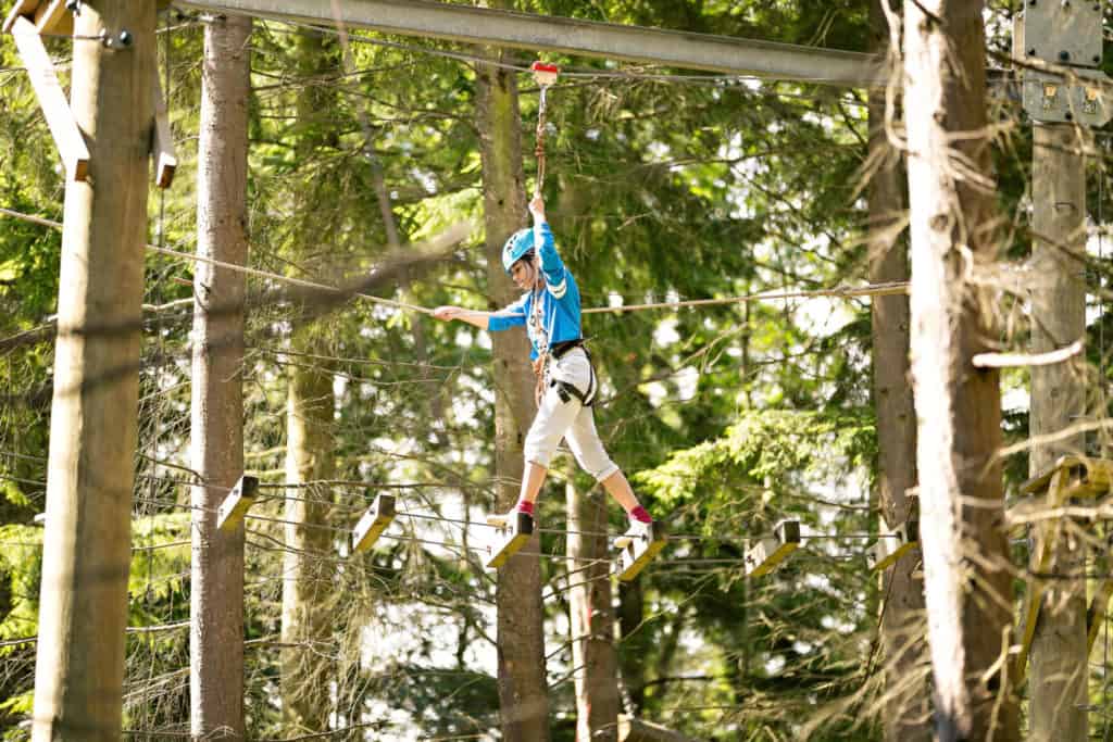 Child on high ropes course at Colomendy Centre, North Wales