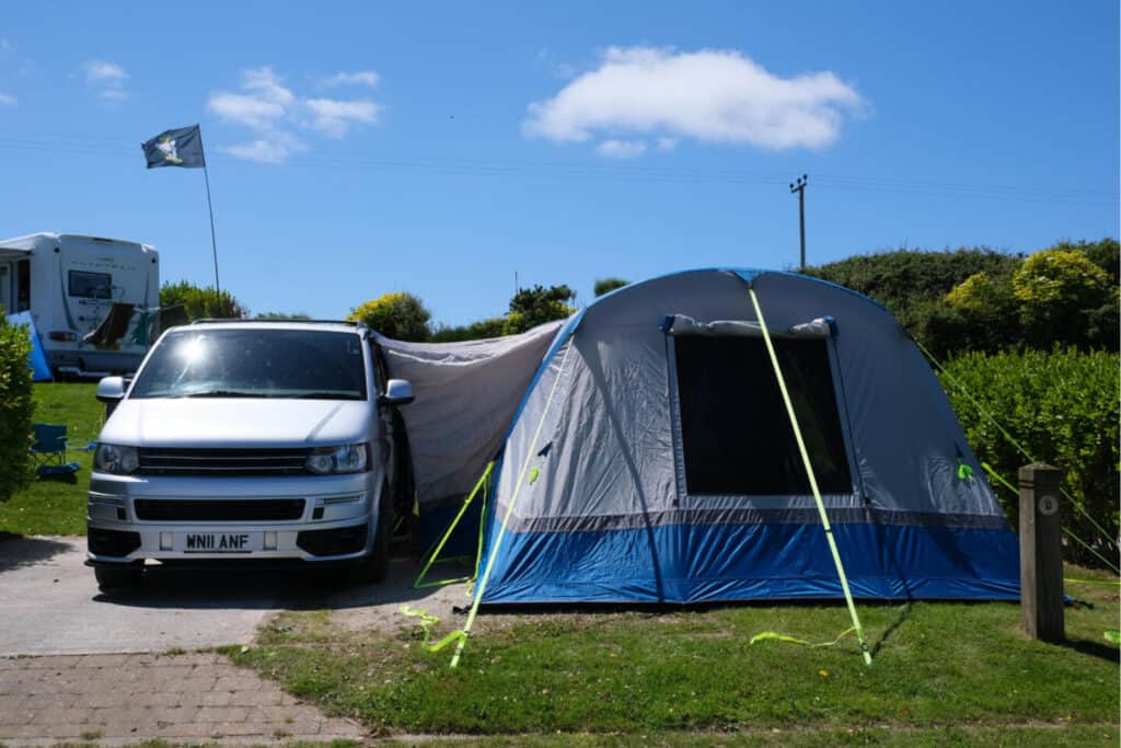 OLPRO awning and VW T5 van on campsite pitch