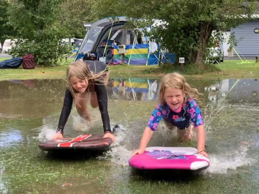 Kids board boarding at campsite