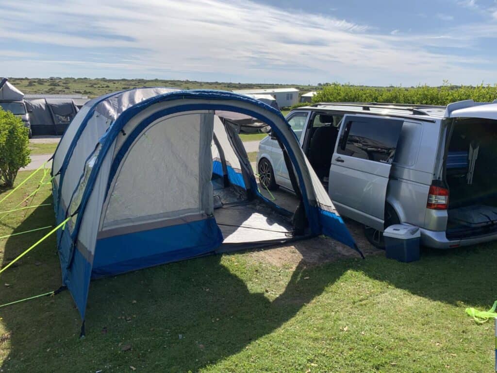 Inflatable campervan awning on side of van on camping pitch