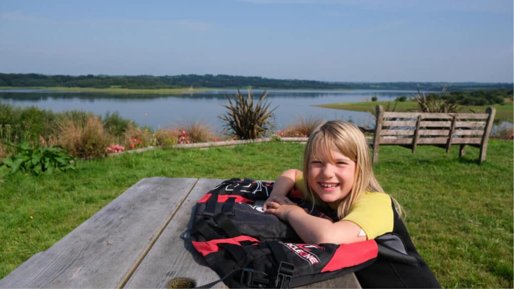 Tot at Roadford Lake visitor centre, sitting on a picnic bench overlooking the lake
