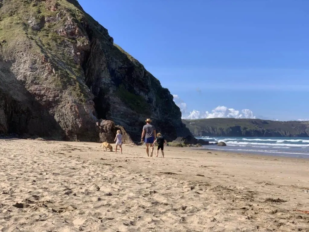 Family walking on Walking on Perran Sands beach