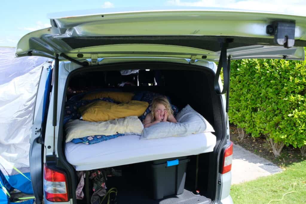 Child in Forty Winks bed in back of VW Transporter