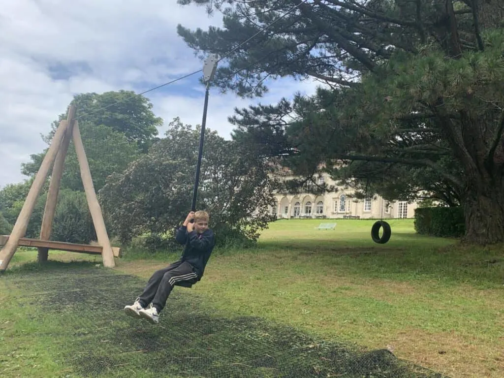 Child on zipwire outside hotel