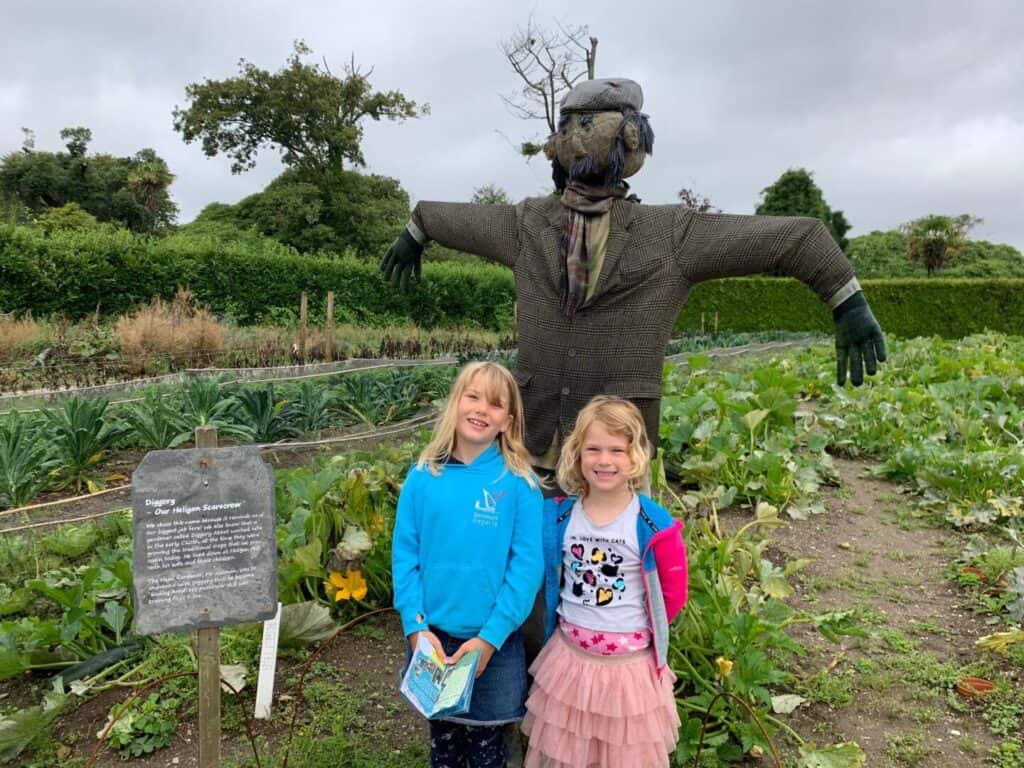 Kids with scarecrow in vegetable patch at Lost Gardens of Heligan in Cornwall