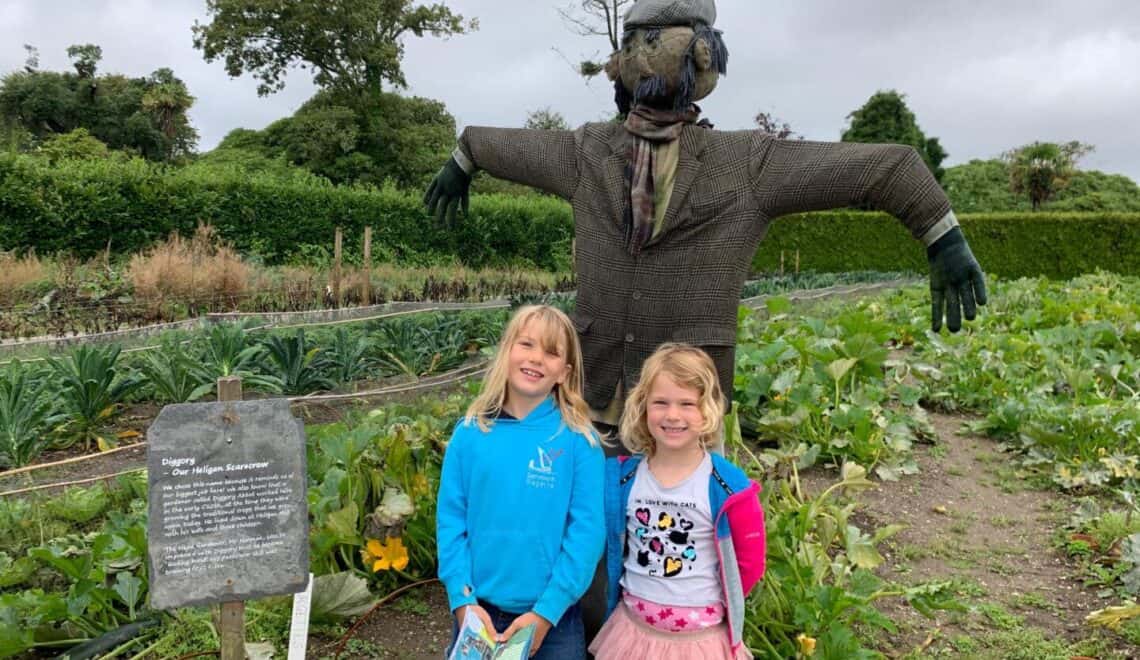 Kids with scarecrow in vegetable patch at Lost Gardens of Heligan in Cornwall