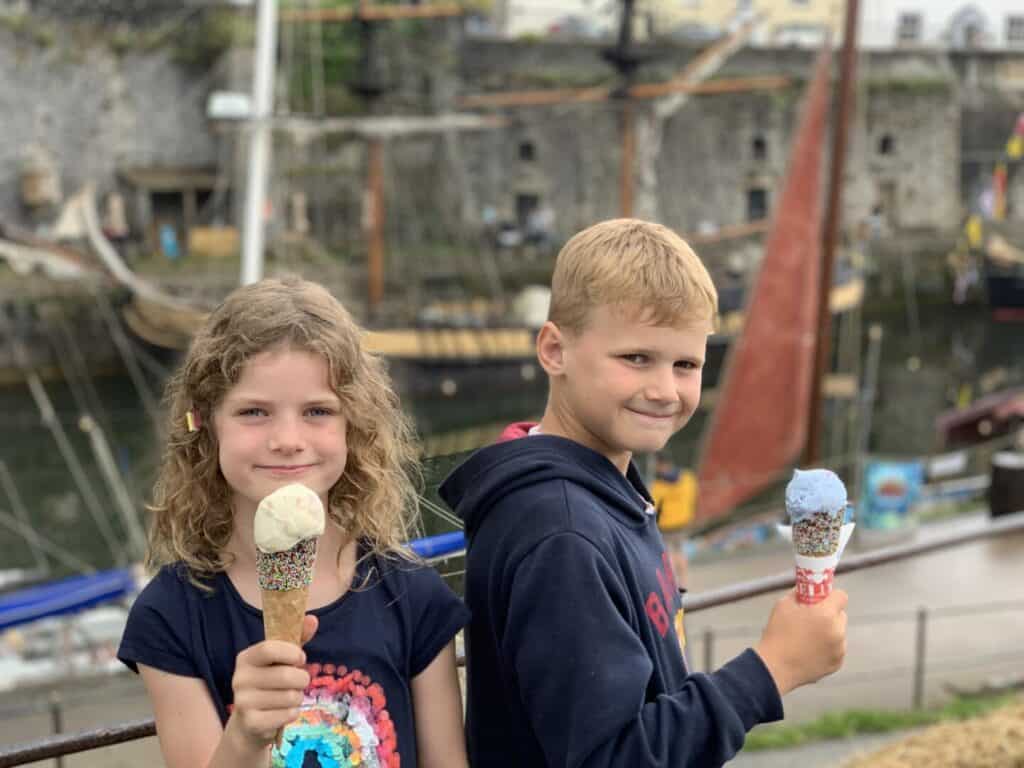 Children holding ice creams in front of Tallships at Charlestown