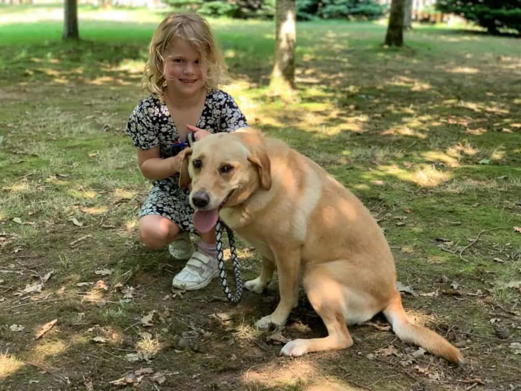Baby holding Tin Box Dog
