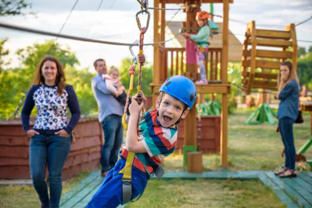 Boy on zip wire on adventure playground