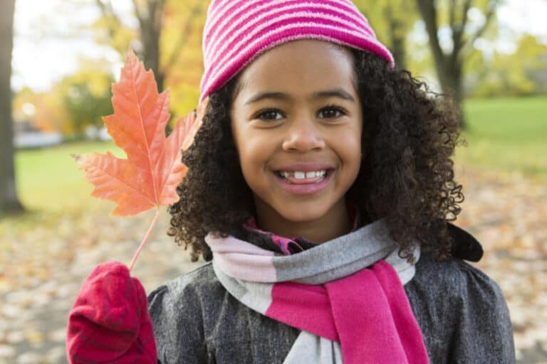 Girl holding a autumn leaf