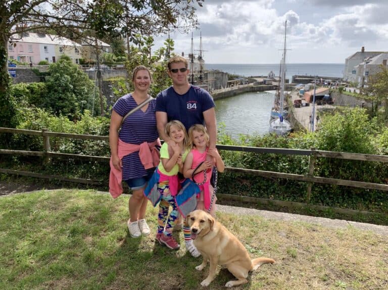 Tin Box family standing in front of Charlestown Harbour near St Austell in Cornwall