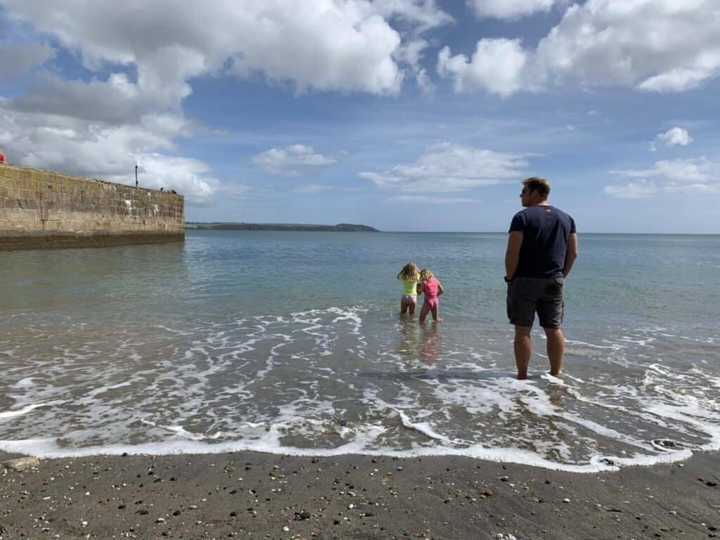 Kids paddling at Charlestown Beach in Cornwall