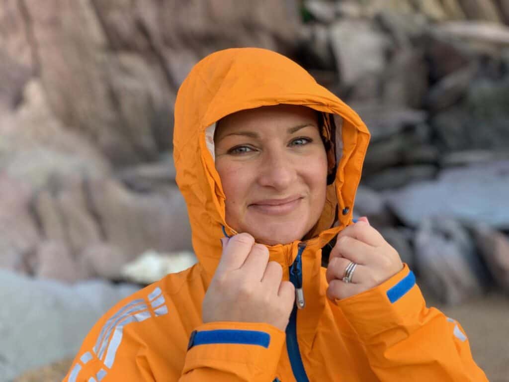 Claire adjusting the hood of the Keela Ladies Storm jacket