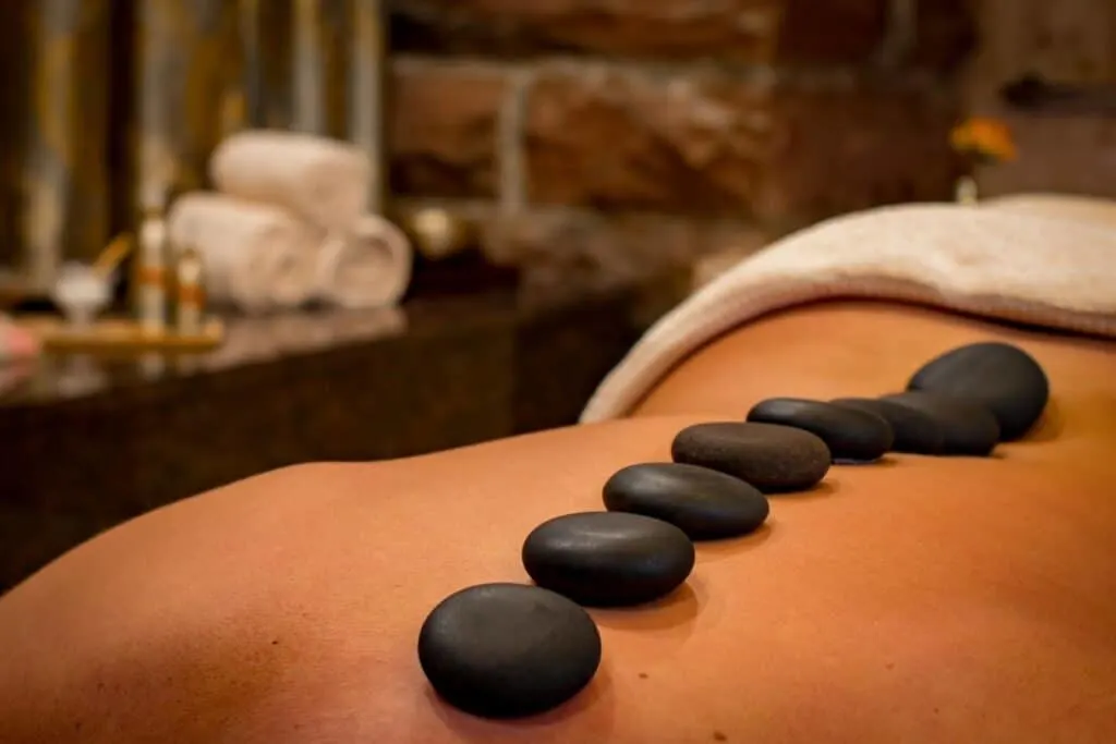 Person laid on spa bed having a hot stone spa treatment