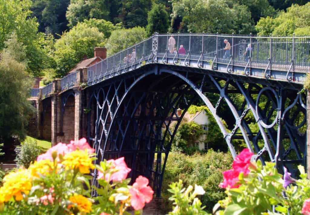 View of the iron bridge with flowers in the foreground