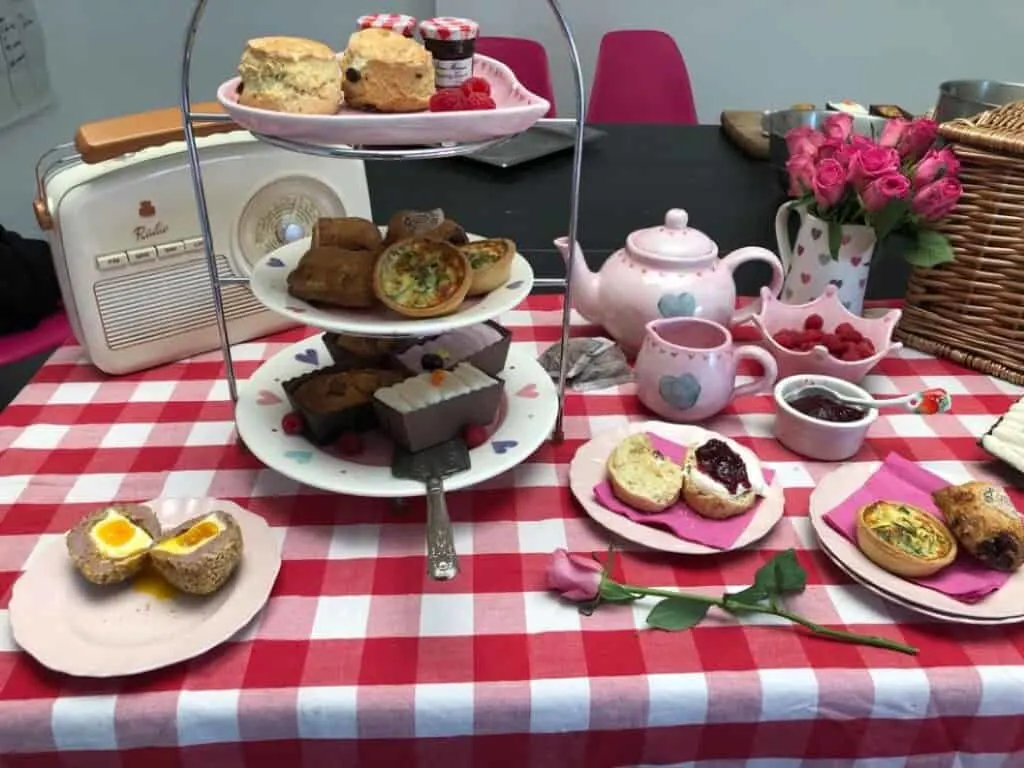 Cakes, scones and sandwiches laid out on a table