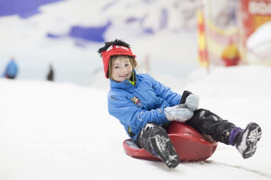 Boy on sledge at Sledge ‘O’ Mania in The Snow Park at Chill Factore in Manchester