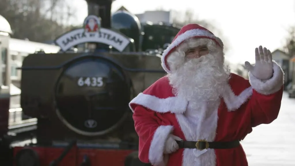 Santa stood on platform infant of steam train at Bodmin & Wenford Railway