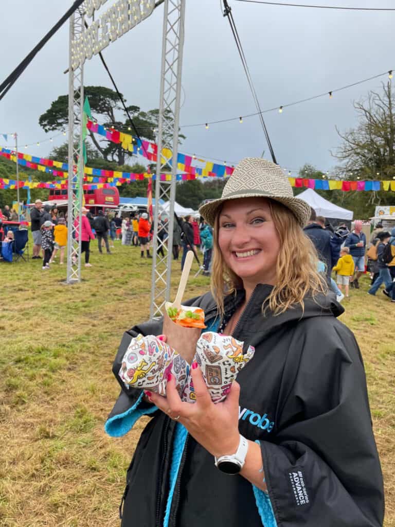 Claire holding wrapped food at festival