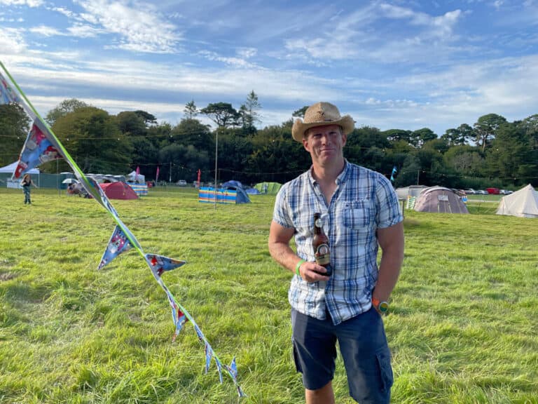 Mr Tin Box drinking cider on festival campsite