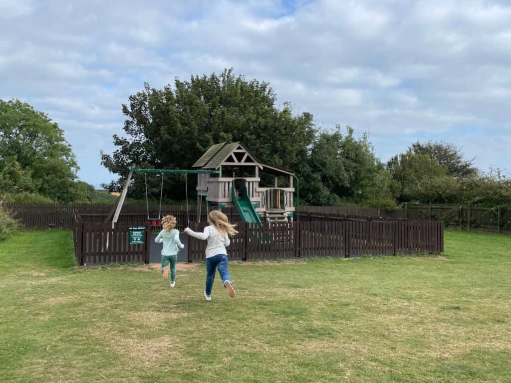 Children running towards a playground