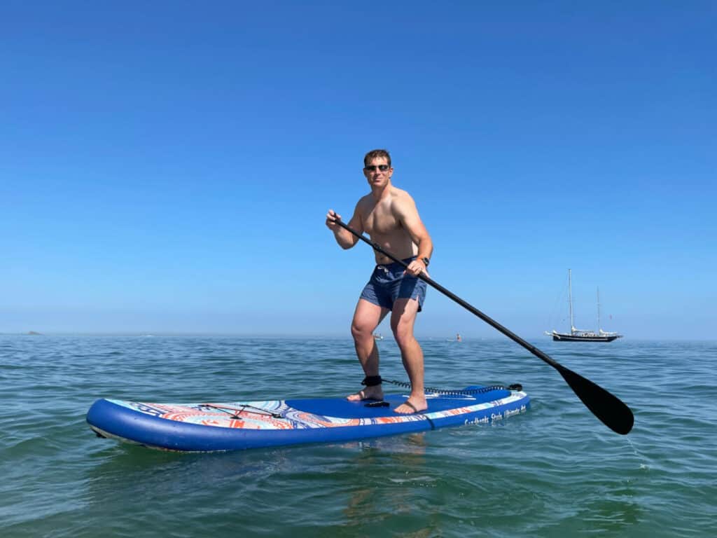Mr Tin Box on paddle board on the sea