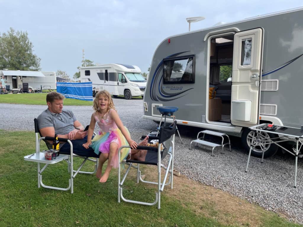 Mr Tin Box and Baby sat outside caravan on the Dartmouth Camping and Caravanning Club Site