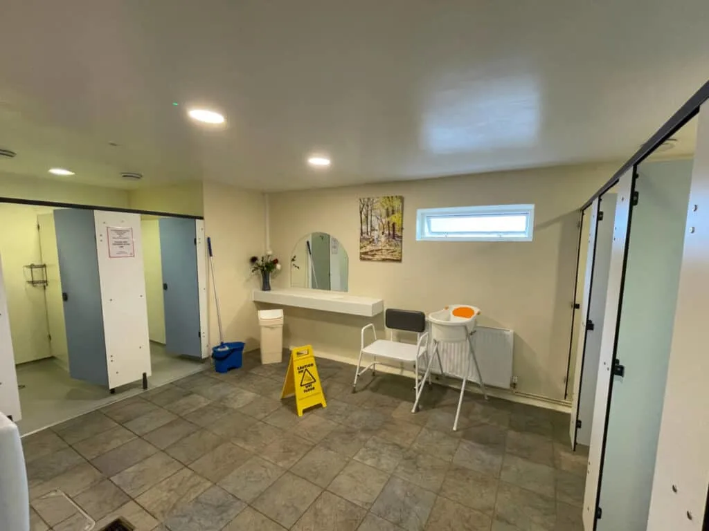 Accessible shower seat and baby bath in shower block