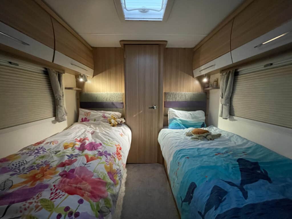 Twin fixed beds in caravan made up with children's bedding