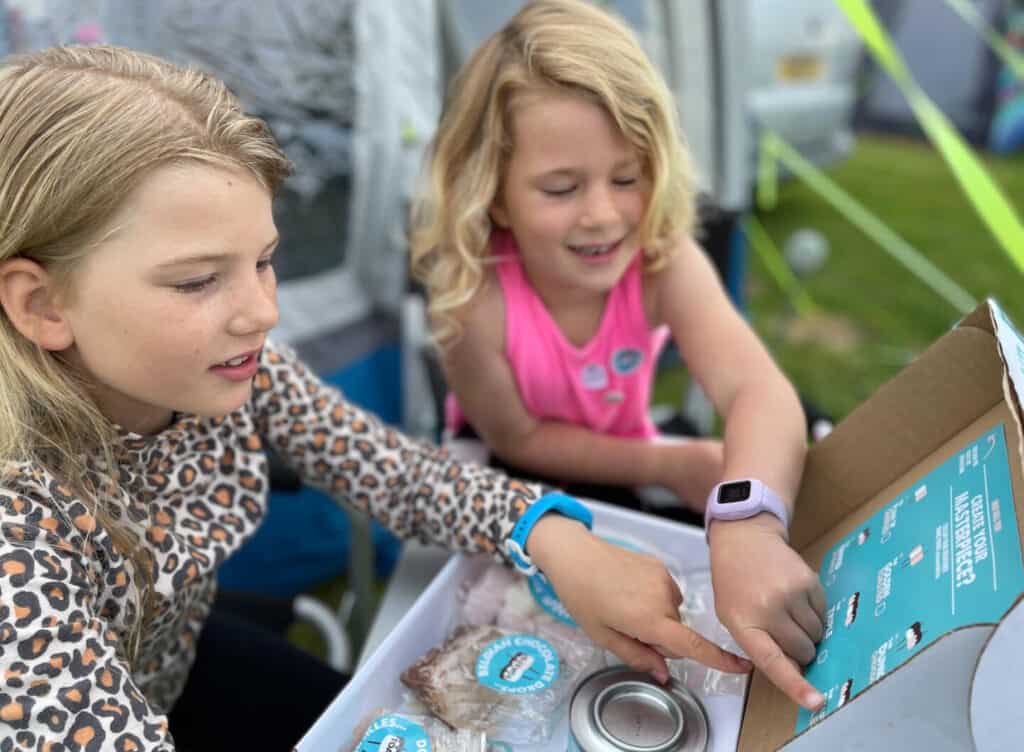 Girls looking at marshmallow toasting kit