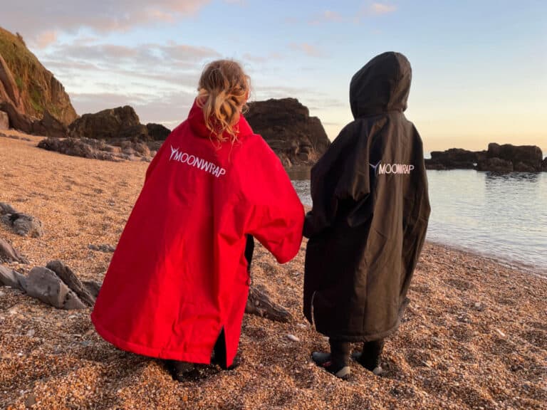 Children wearing Moonwrap waterproof changing robes on beach
