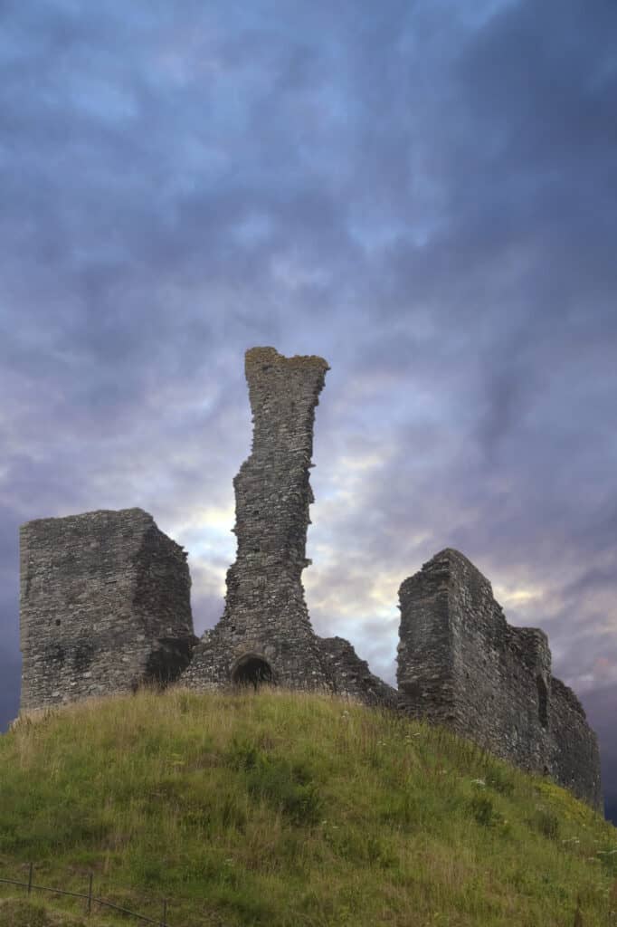 The ruins of Okehampton Castle against the gray sky